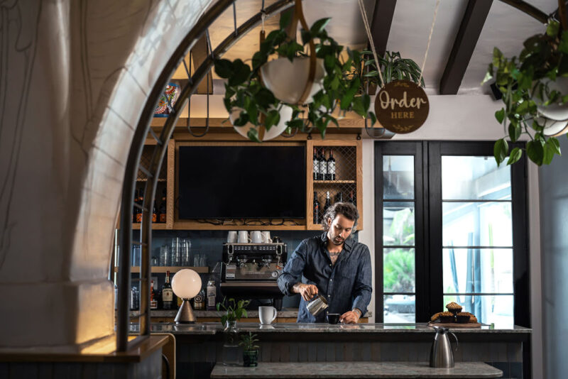 Man pouring coffee at Cafe Lido with an exceptional service