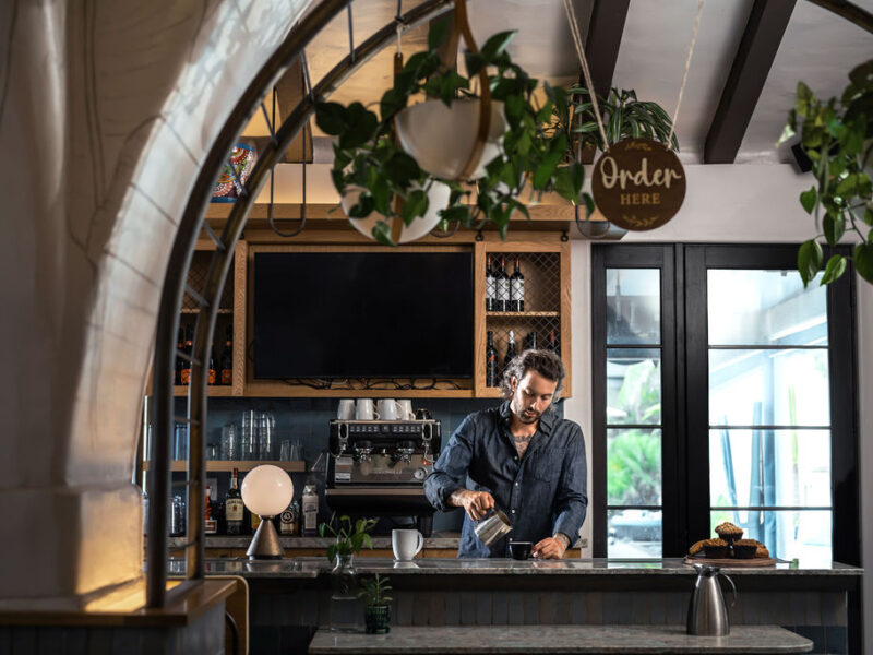 Man pouring coffee at Cafe Lido with an exceptional service